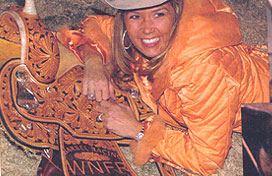 Liz Pinkston running Doc at the 2005 National Finals. Seen below with her new NFR average saddle. "The Bylers offer the 